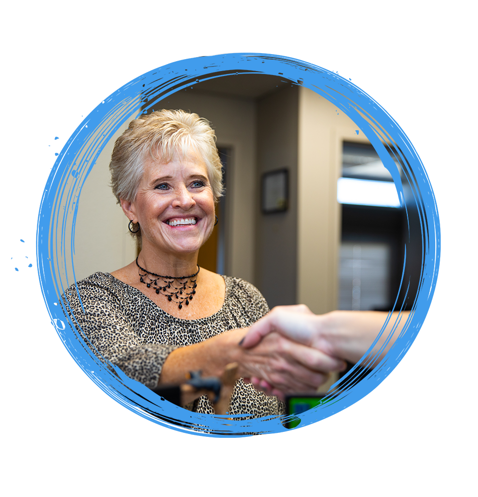 Patient Smiling shaking team members hand