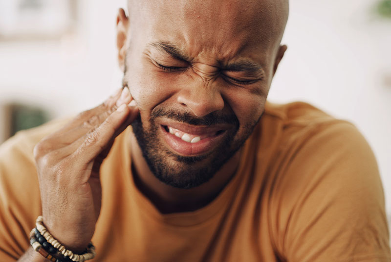 Man holding face in pain